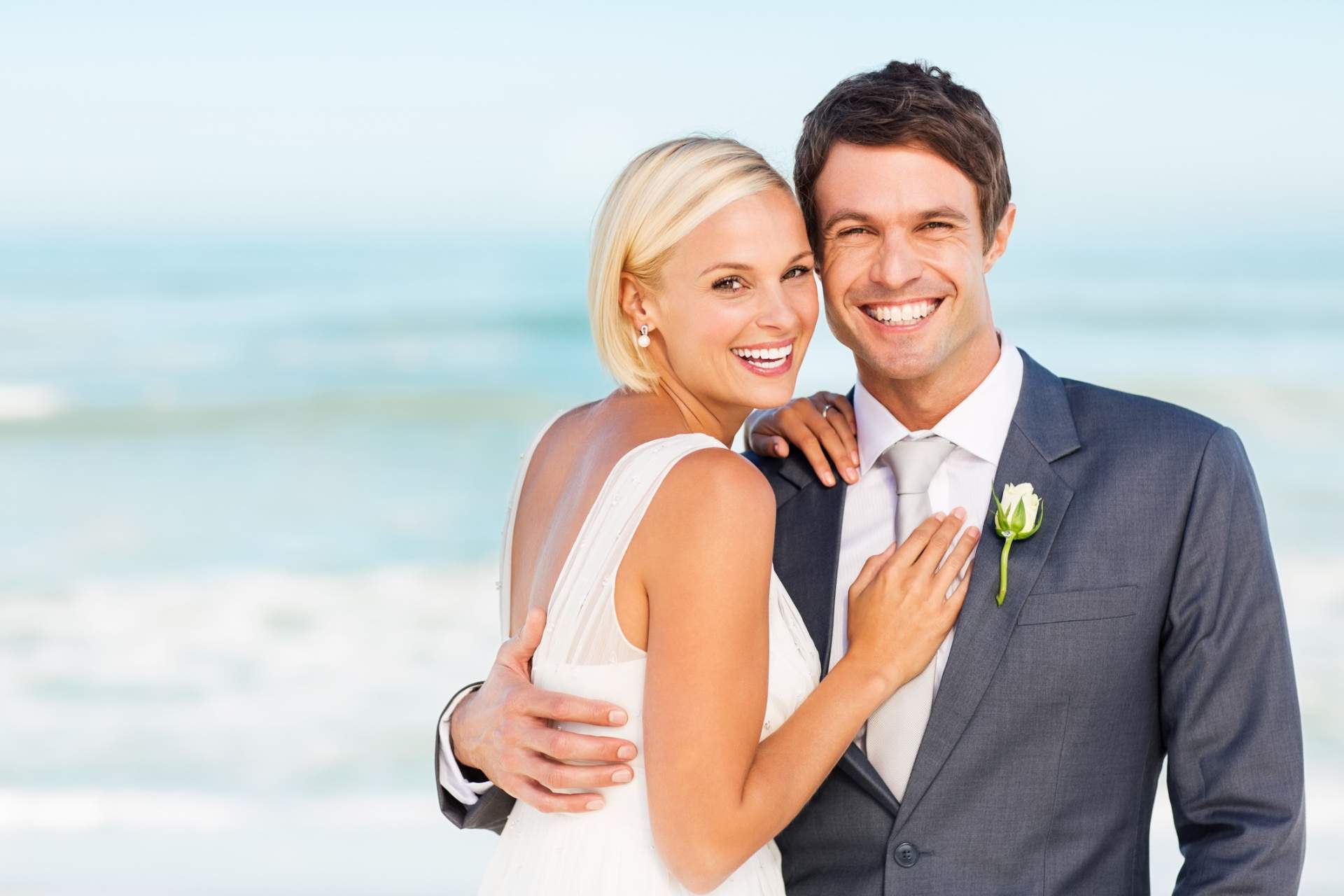 A young happy couple just married on the beach